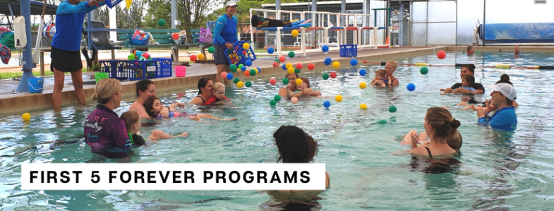 A group activity in a swimming pool with parents and young children